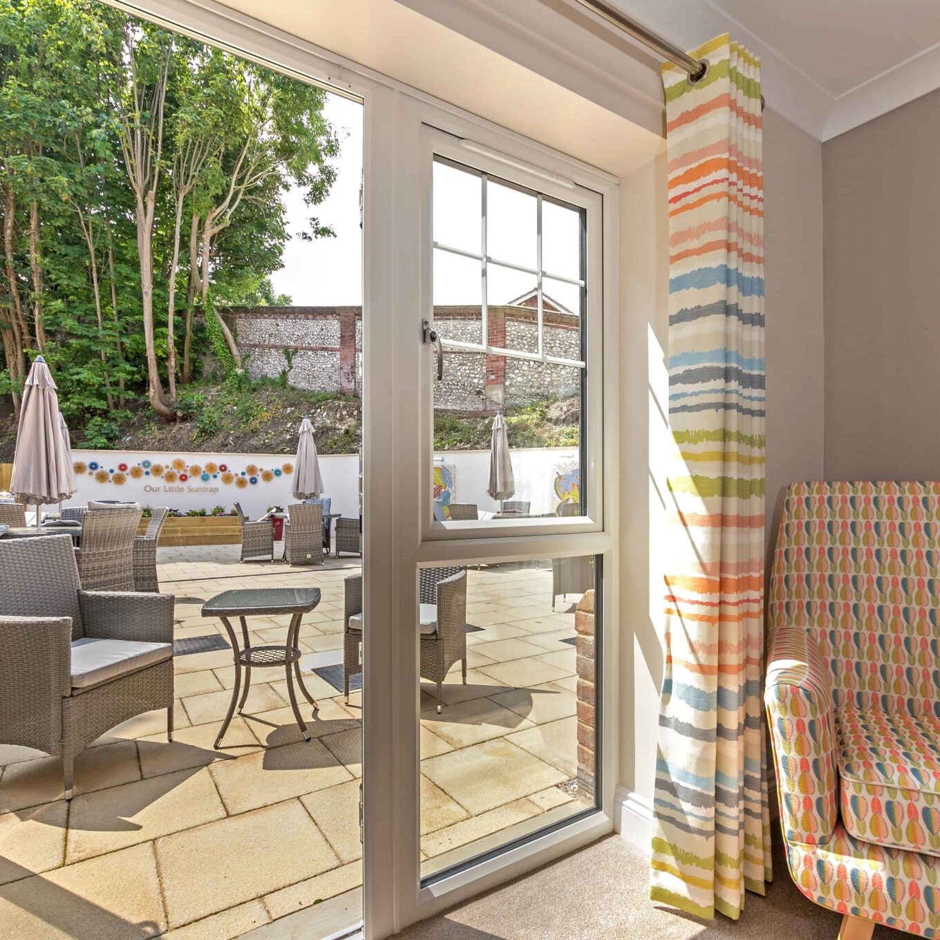 Open door looking onto garden patio at Beechwood Grove Care Home in Eastbourne