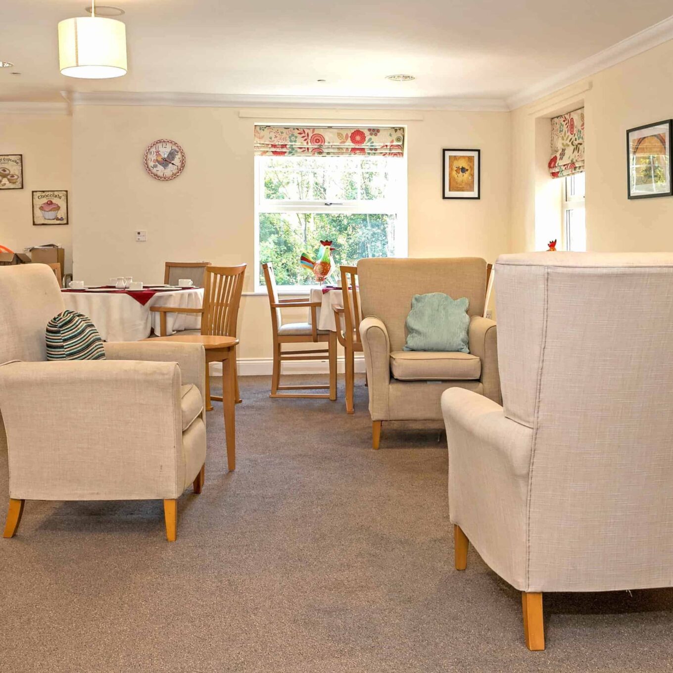 Lounge area with TV at Woodland Grove Care Home in Loughton