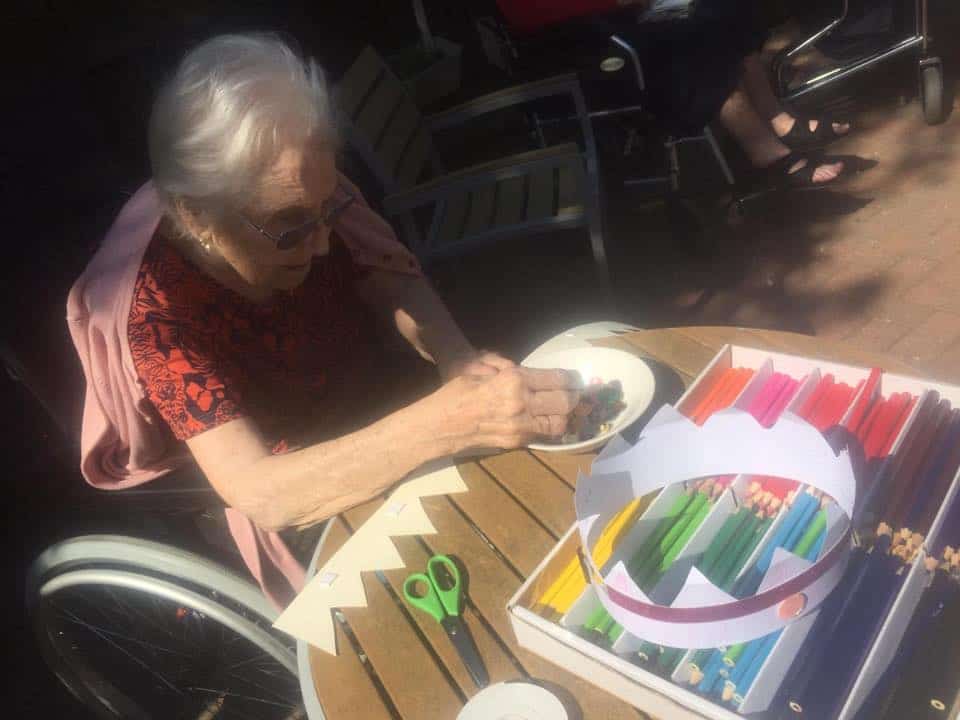 Resident making a crown using arts and crafts