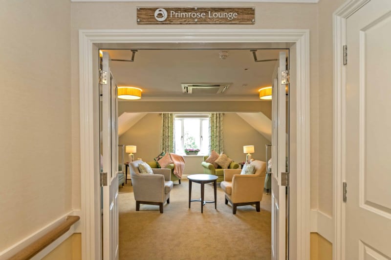 Open doorway to Primrose lounge area at Beechwood Grove Care Home in Eastbourne