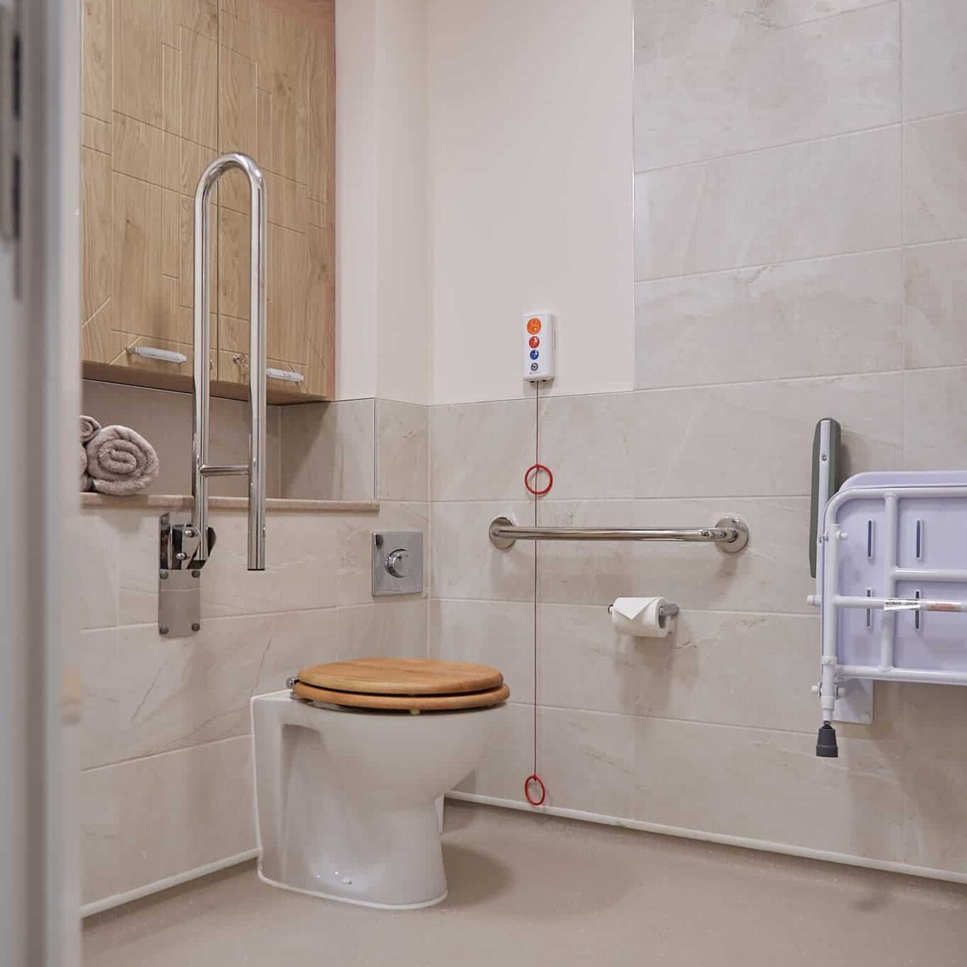 Bathroom with toilet and emergency cord at Lambwood Heights Care Home in Chigwell