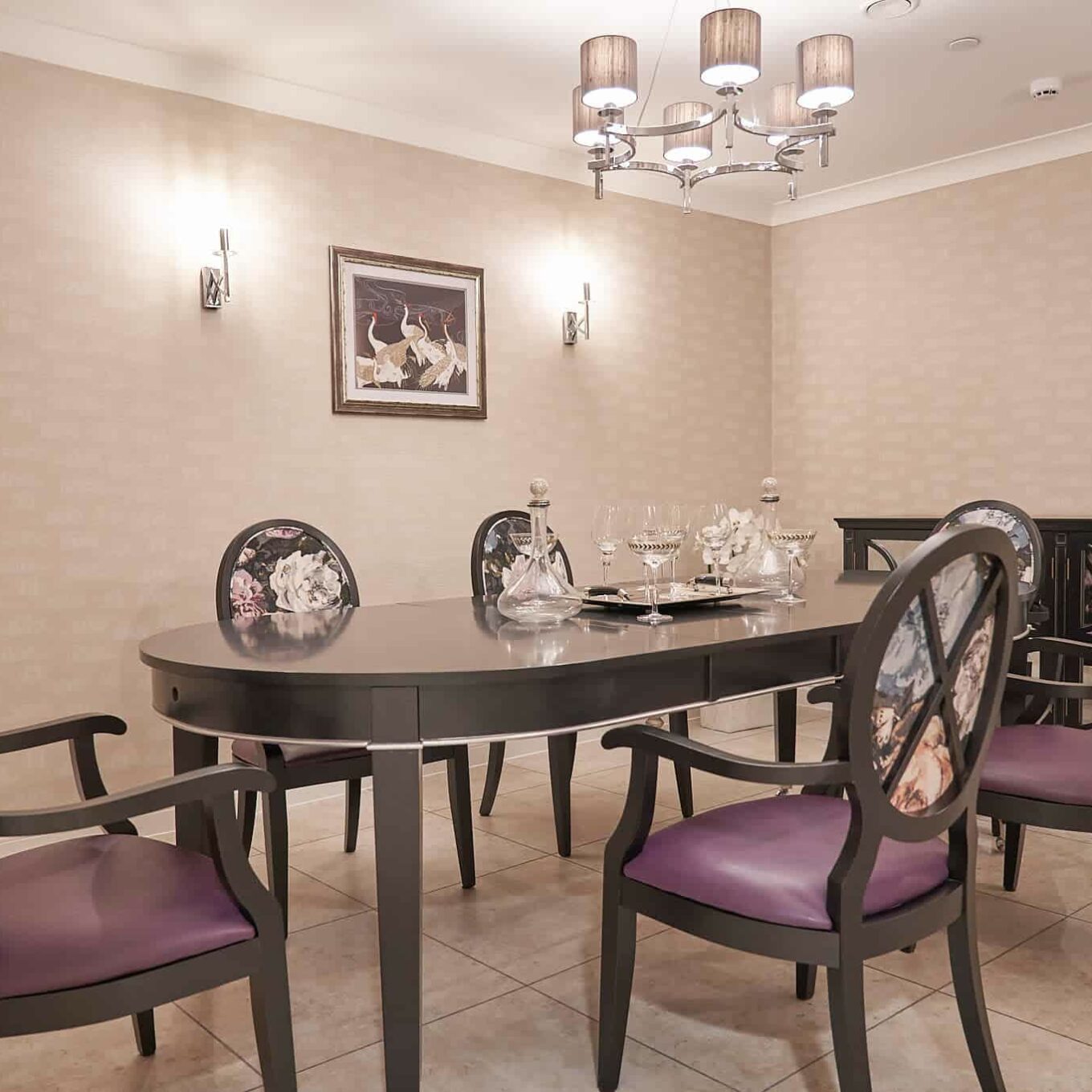 Dining room with six chairs and a table at Oakland Care Home in Chigwell