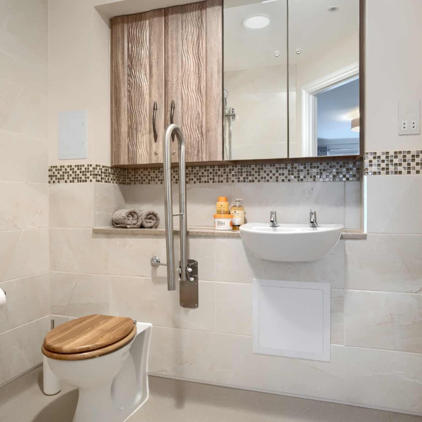 Bathroom with toilet, sink and cupboards at Elmbook Court Care Home