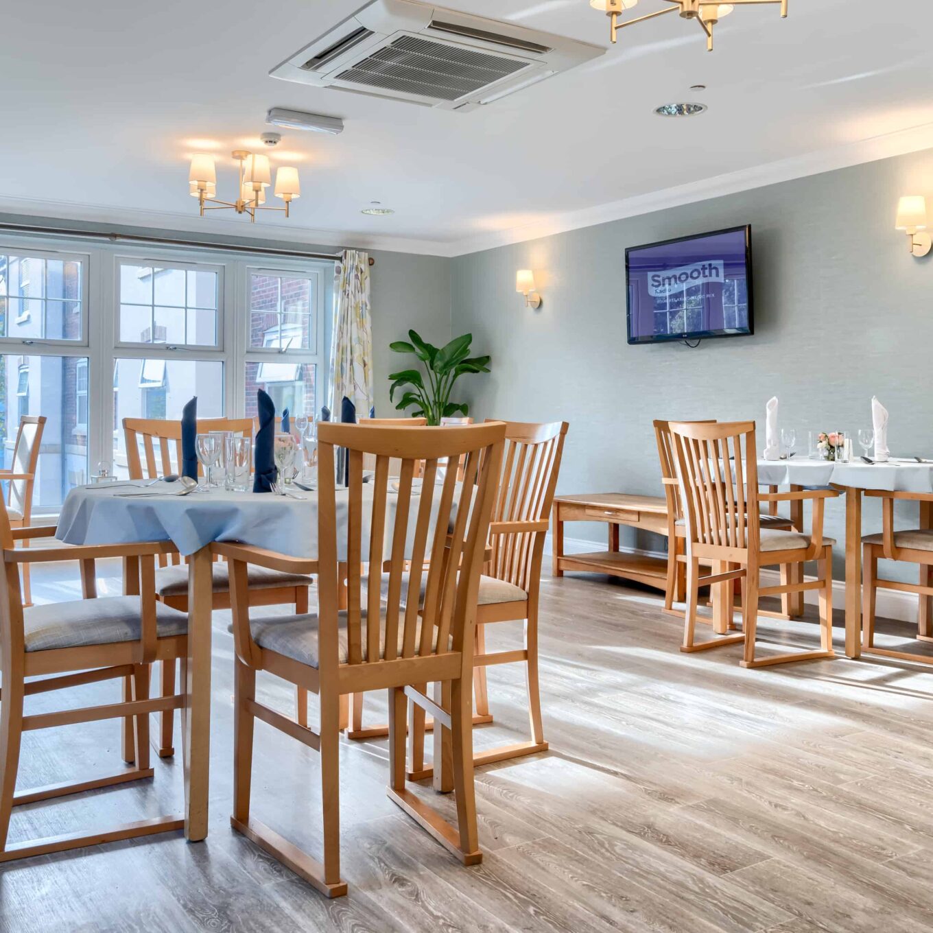Smooth radio playing on TV in dining room at Woodland Grove Care Home