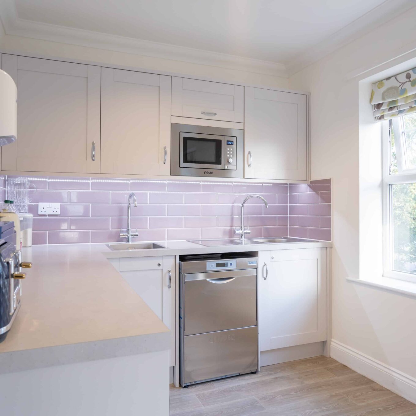 Kitchen facility with a toaster, microwave and sink at Woodland Grove Care Home in Loughton