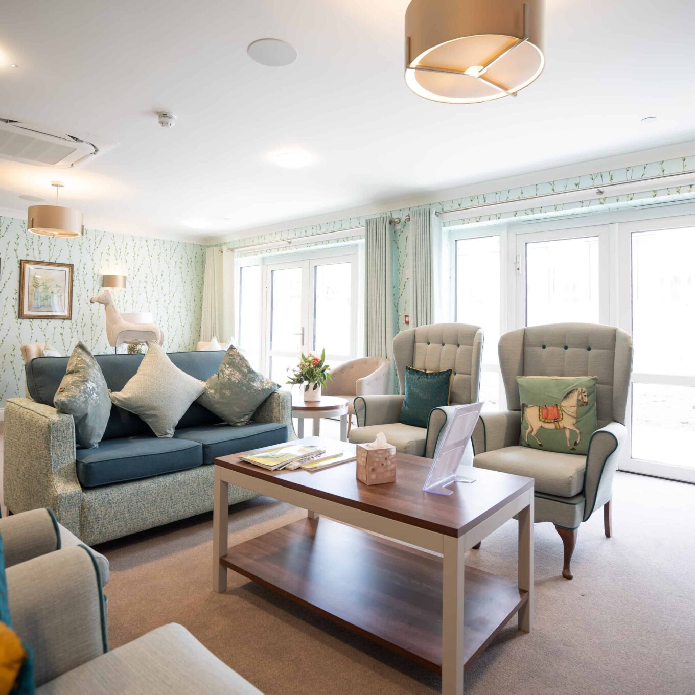 Lounge area with sofa, chairs and coffee table at Elmbrook Court Care Home