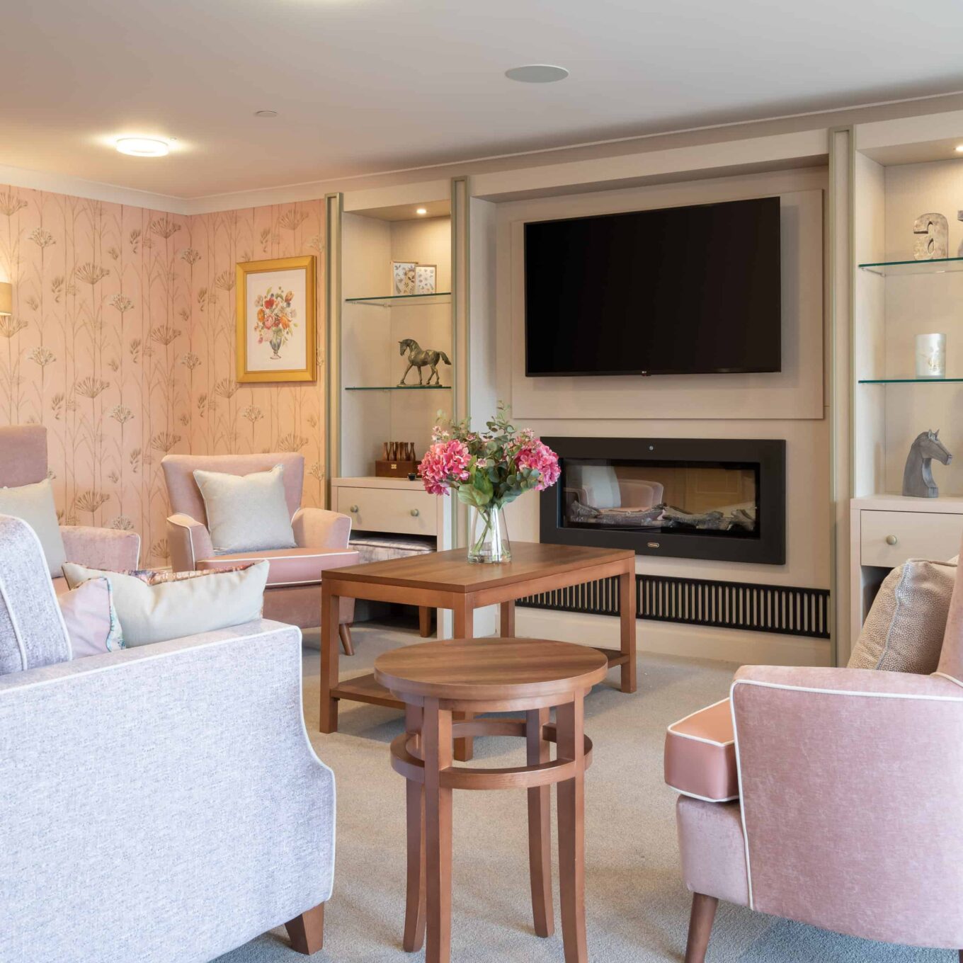 Lounge area with chairs, coffee table and TV at Elmbook Court Care Home in Wantage