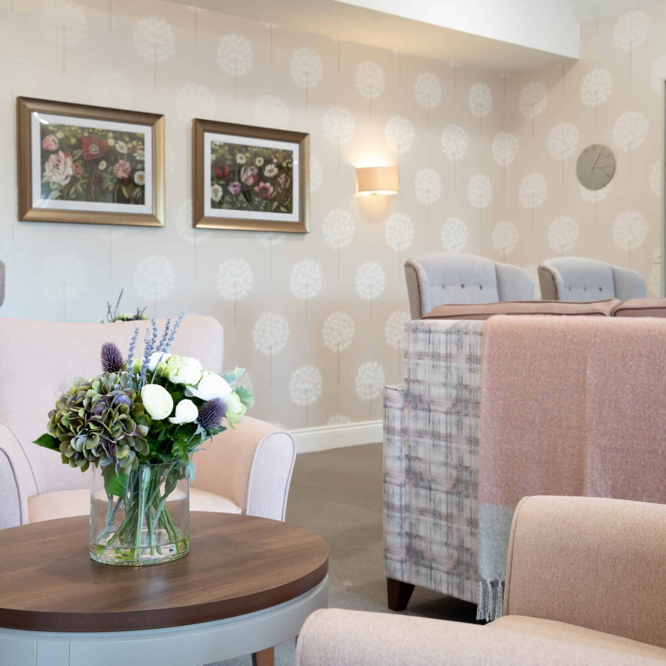 Seating area with flowers on table at Elmbrook Court Care Home in Wantage