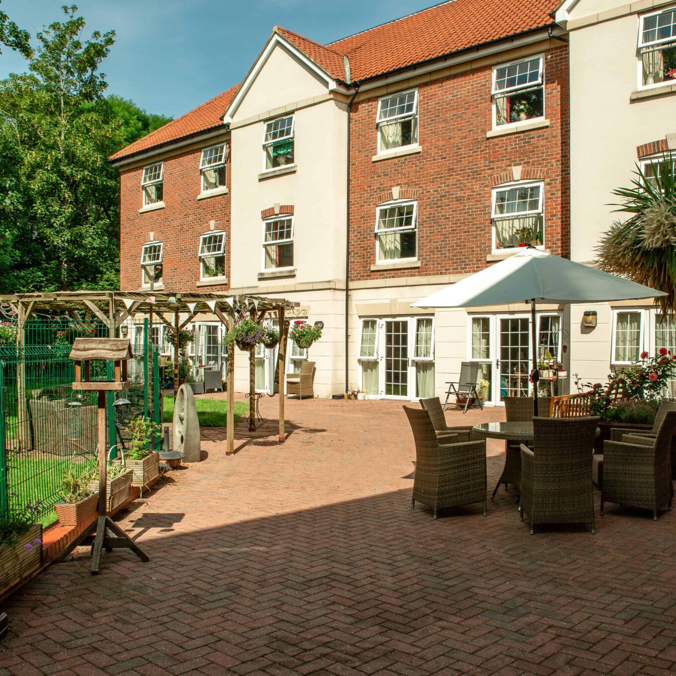 Outdoor garden patio area at Woodland Grove Care Home in Loughton, Essex