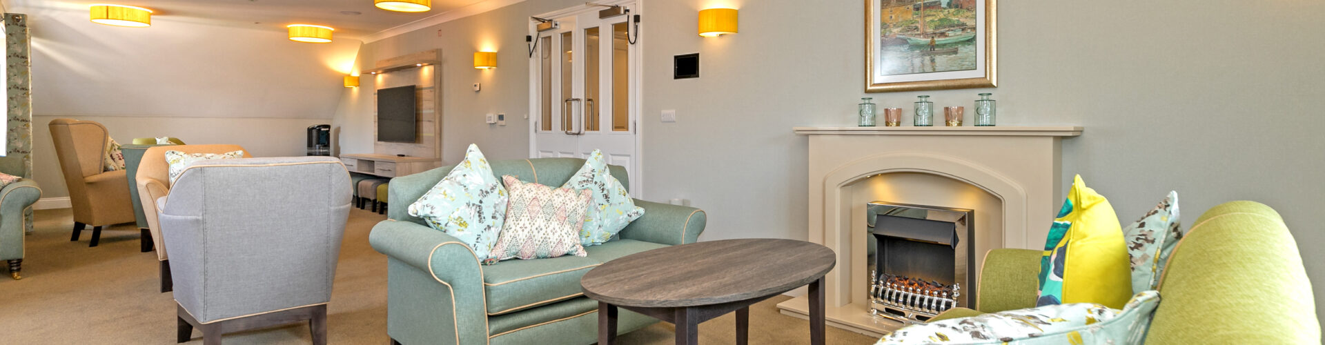 Lounge area with fireplace at Oakland Care Home in Eastbourne