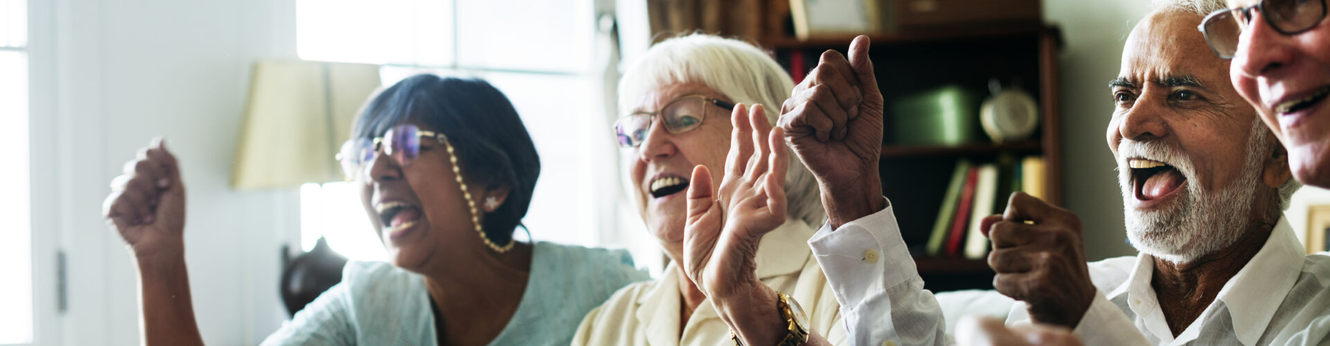 Senior people watching televison together in a care home