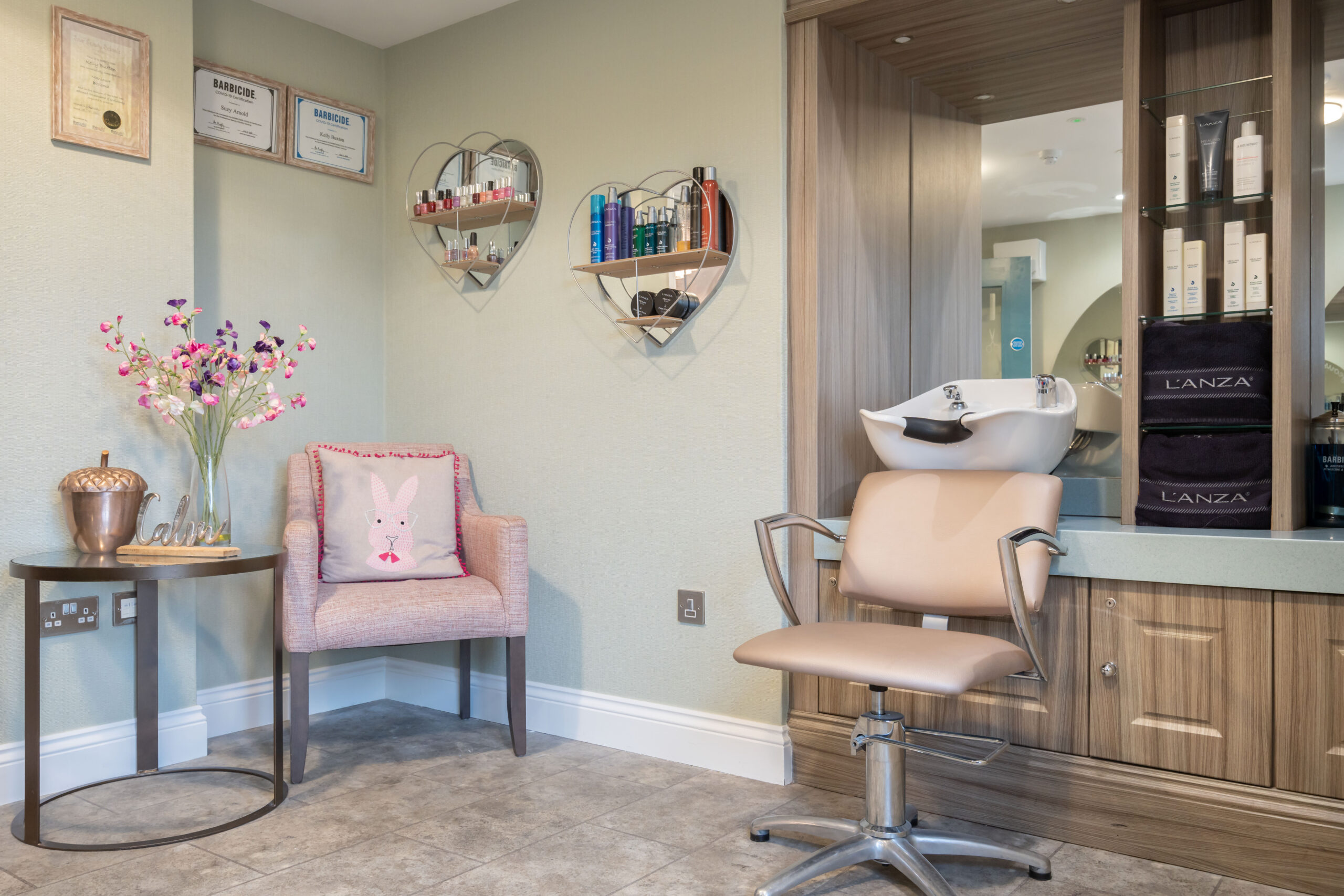 Hair salon with sink and hair products at Beechwood Grove Care Home in Eastbourne
