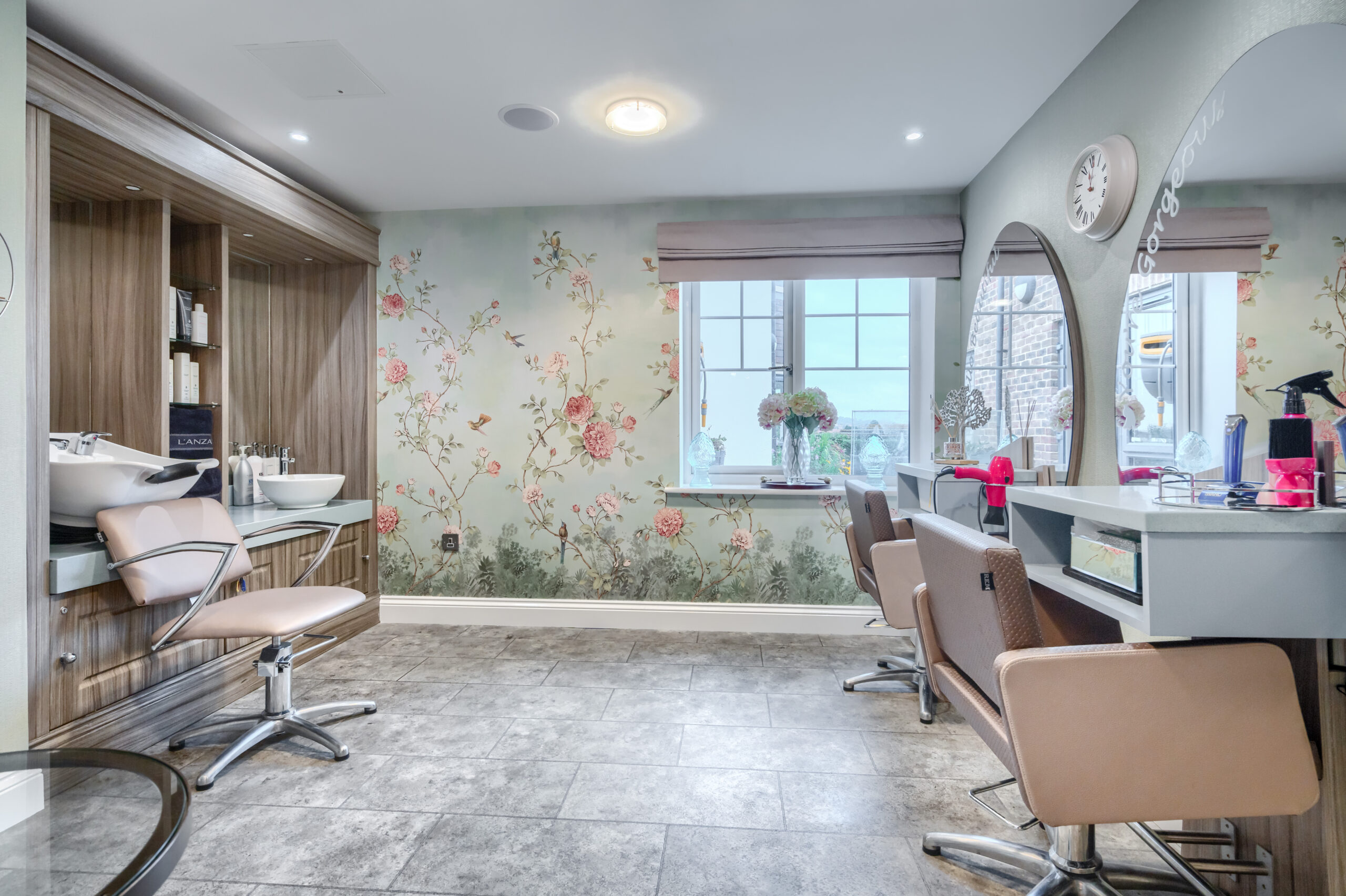 Hair salon with big round mirrors at Oakland Care Home in Eastbourne